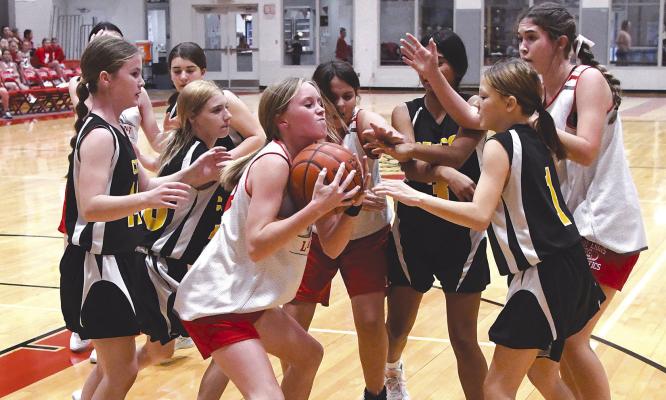 Eighth grader Hattie Fikes battles for possession during the Lady Cubs game against Cisco. The junior high girls teams struggled this week, losing all three games to Cisco Donn ie Lucas / Albany News