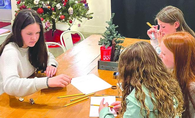 Several members of the Shackelford County 4-H club work on Christmas cards that will be sent to nursing home residents. The Dec. 8 meeting included shopping for items to donate to the Toys for Tots program and discussing a time for the annual leak-raking project. COURTESY PHOTO