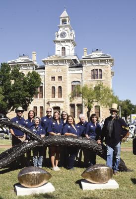 Albany sculptor Joe Barrington (at left, r) and Shackelford 150 committee members unveil the pecan branch and oversize bronze pecan “benches” on the south side of the Courthouse Square. A few minutes earlier, Barrington (below) told about the idea for the branch, which represents the pecan tree near Fort Griffin under which the Shackelford County charter was originally signed. Donnie Lucas / Albany News