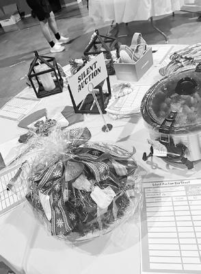 A table full of goodies and silent auction items help raise funding to assist with local missions. The event was held last Saturday.