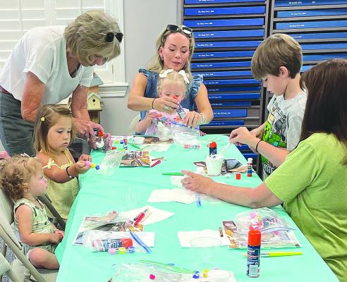 With some help from parents and grandparents, children participating in this year’s Summer Story Hour at the Shackelford County Library work on a craft that corresponds with the story they heard. The library is one of two dozen local organizations that will benefit from Albany Chest funding. File Photo