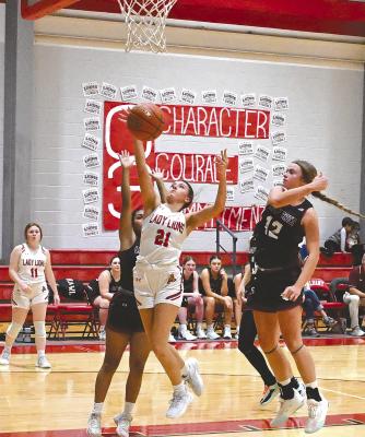 Ashlyn Miller gets the ball inside and goes up for a two-point attempt during the Lady Lions’ district opener against a strong Hawley team on Tuesday night. The Albany girls continue to make progress in building a new program. They will have an open date next Tuesday, then travel to Stamford for another district game on Friday, Dec. 20.