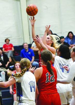 Senior Caroline Holson leaps over an Abilene Christian defender for a shot during the Lady Lions game on Tuesday. The girls will host Roscoe on Saturday morning. Photo by All i McDaniel
