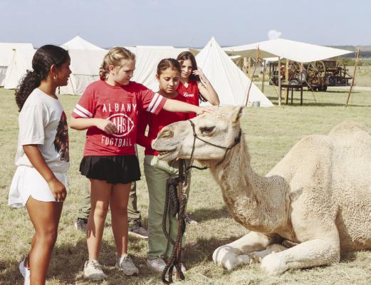 Several NSES fifth graders get a chance to rub the head of a member of the Camel Corps during Living History Days at Fort Griffin State Historic Site. The event was held Oct. 10-11. Donnie Lucas / Albany News