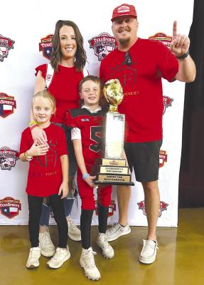 True Maberry (above, front) holds up the TexaSports 8U state championship trophy at Frisco’s Ford Field, surrounded by his family. Maberry plays for Abilene Finest 8U team. Courtesy Photo