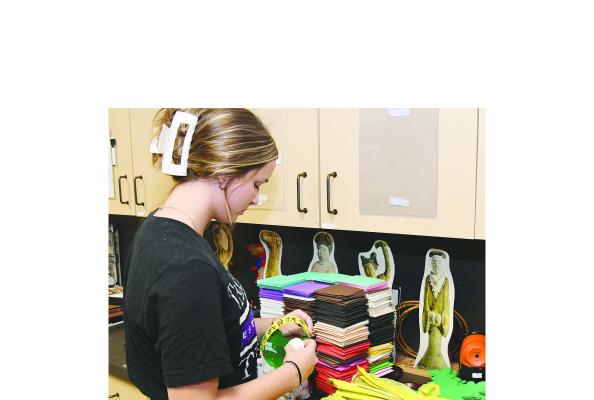 Teen Council member Emily Schedule works to get craft materials ready in preparation for this weekend’s family-friendly event at the Old Jail Art Center. Participants will celebrate the “Moon Festival,” with traditional Chinese treats, games, and activities. Donnie Lucas / Albany News