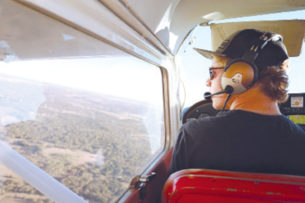 Cache Clark, an Albany High School junior, pilots a plane after earning his pilot’s license at just 17 years old, following over a year of training and over 75 hours of logged flight time.